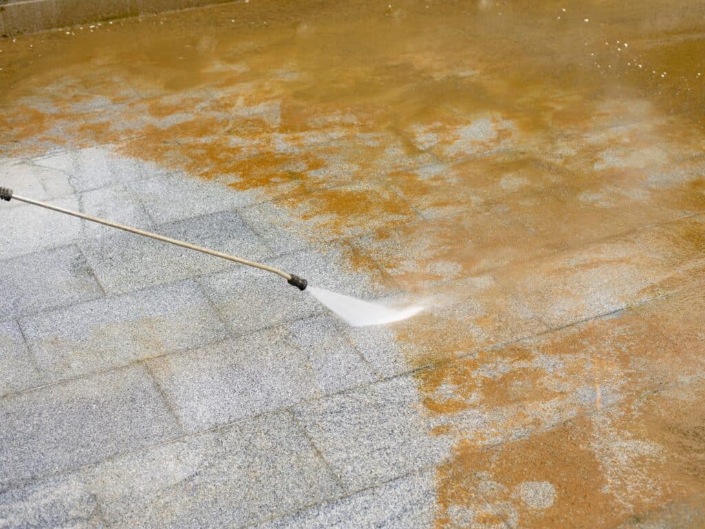 Removing rust from a driveway.